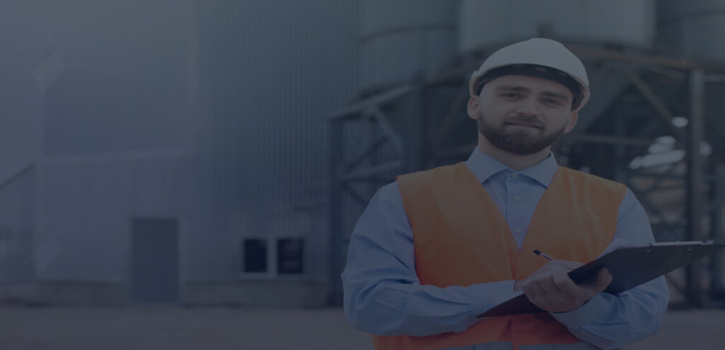 A manufacturing supervisor leads an OSHA safety training session for a team on the factory floor.