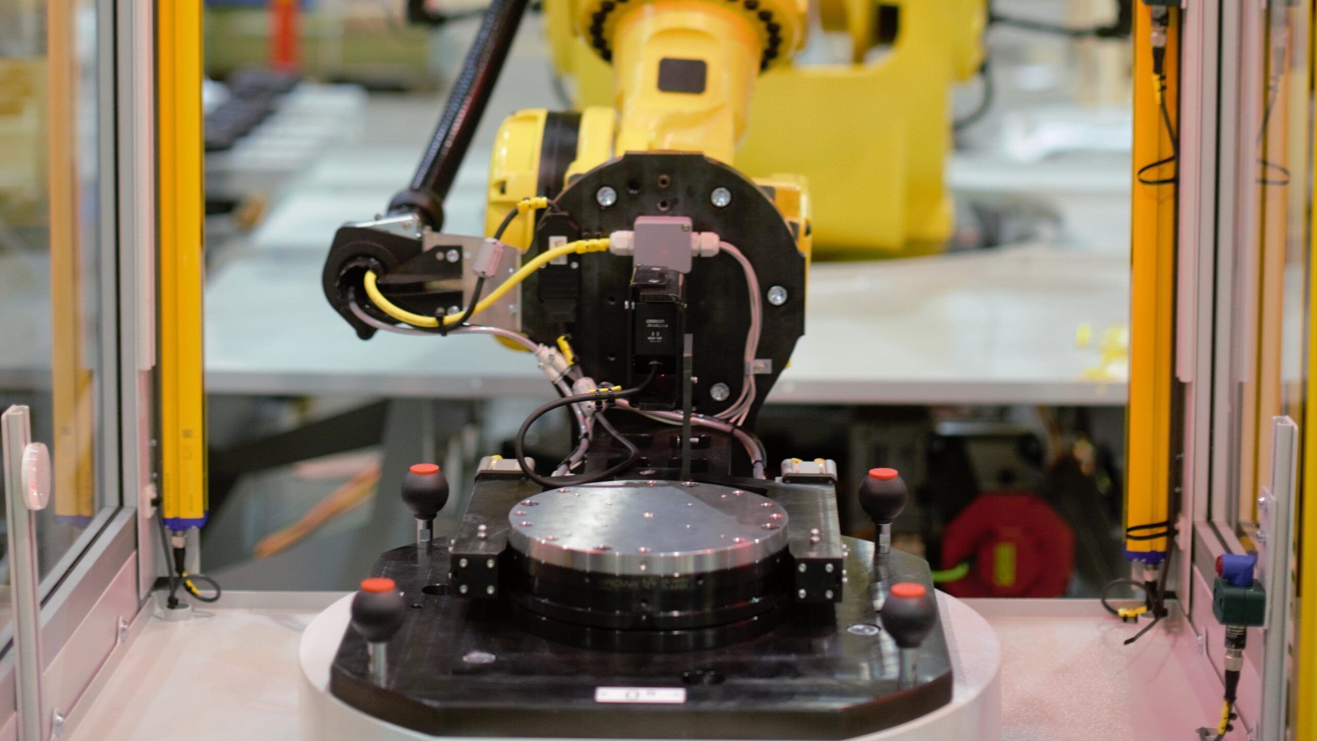A collaborative robot arm performing a precision assembly task alongside a human operator in a modern manufacturing facility.